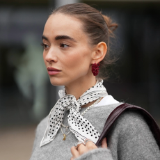Woman wearing a bandana with a gray sweater